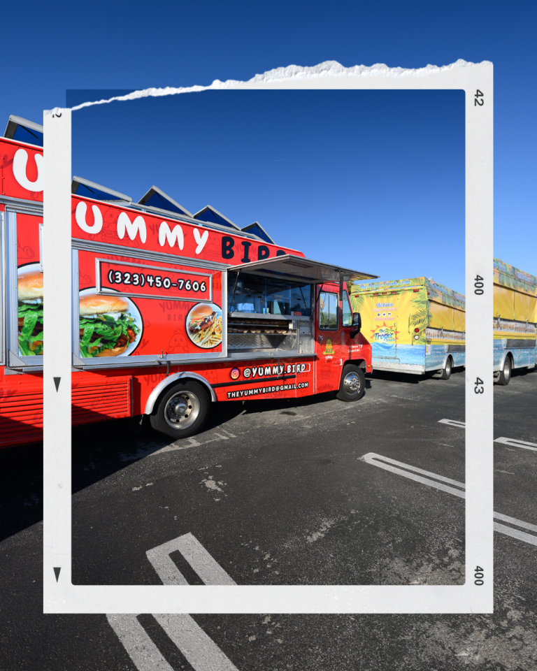 Two food trucks stationed beside each other, one red and one yellow, ready for Tate McRae's album release party.